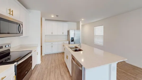 a kitchen with a sink stove and refrigerator