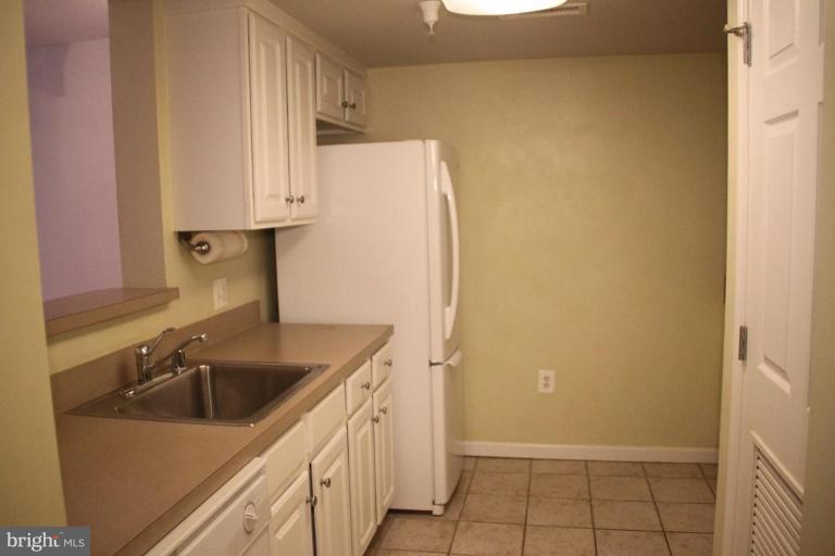 11710 Old Georgetown Road, Unit 824 Rockville, MD 20852 - Photo 9 of 12 a kitchen with a sink and cabinets