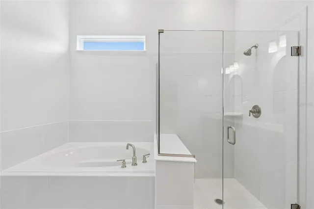 a bathroom with a bathtub and a shower
