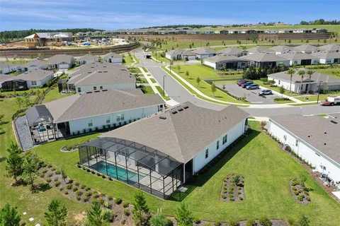 an aerial view of a house with a big yard