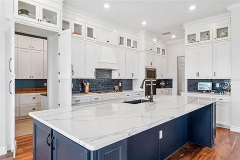 a kitchen with stainless steel appliances kitchen island granite countertop a sink and cabinets