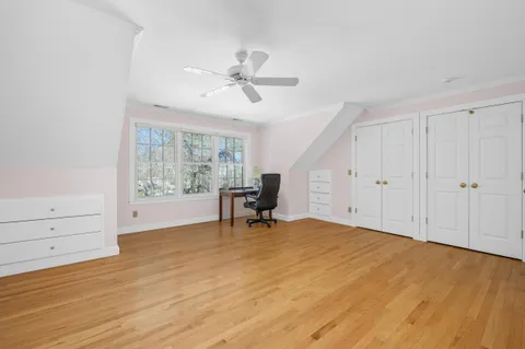 a spacious bedroom with a bed and a window