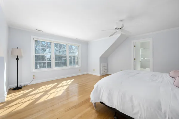 a bedroom with two beds and painting on the wall