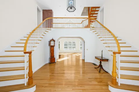 a view of entryway and hall with wooden floor