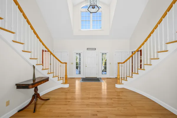 a view of entryway and hall with wooden floor