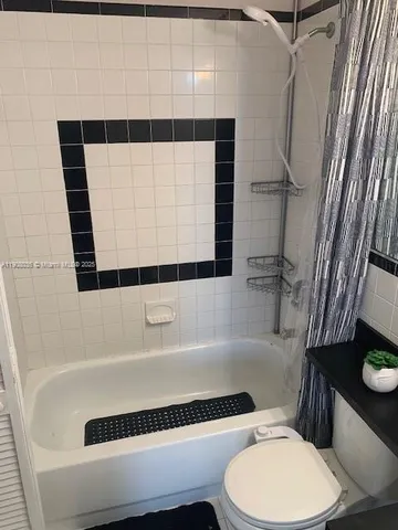 a bathroom with a toilet a sink and bathtub