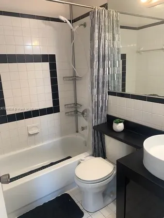 a bathroom with a toilet a sink and bathtub