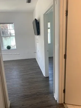 a view of hallway with wooden floor