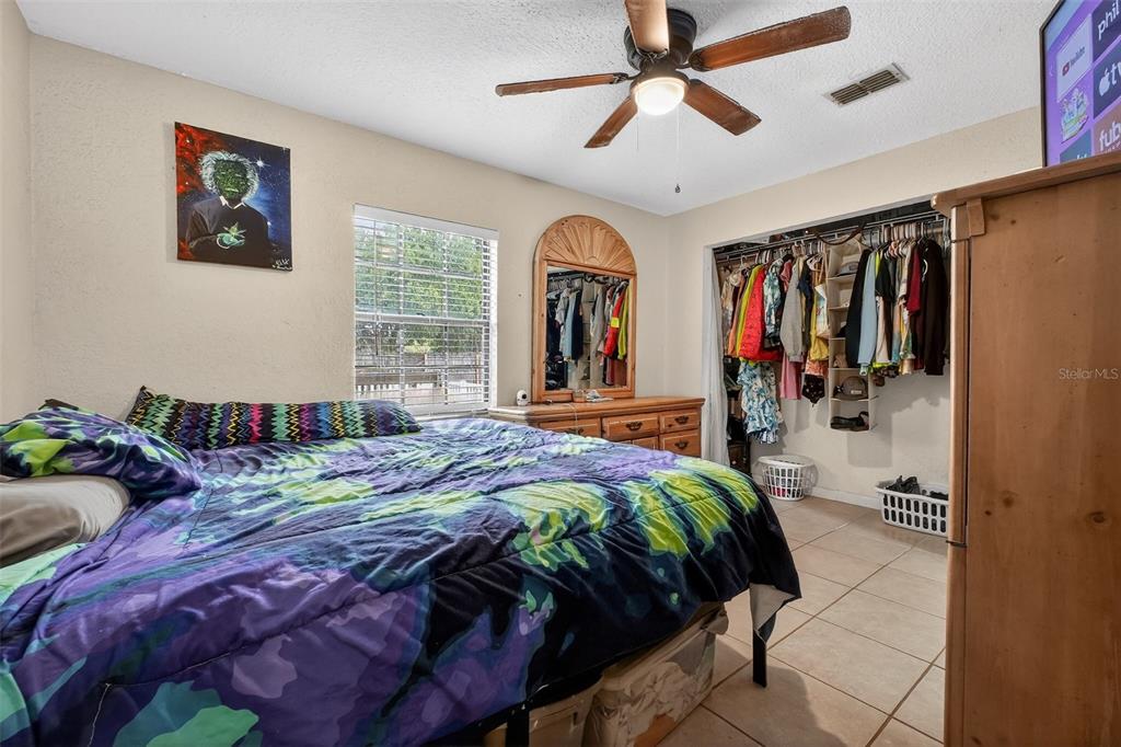 1644 Ruth Street Cocoa, FL 32926 - Photo 15 of 38 a bedroom with bed and a chandelier