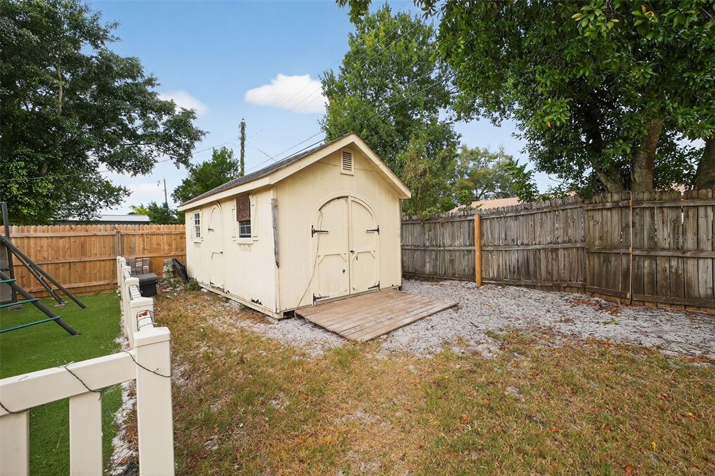 1644 Ruth Street Cocoa, FL 32926 - Photo 31 of 38 a view of backyard with wooden fence and trees