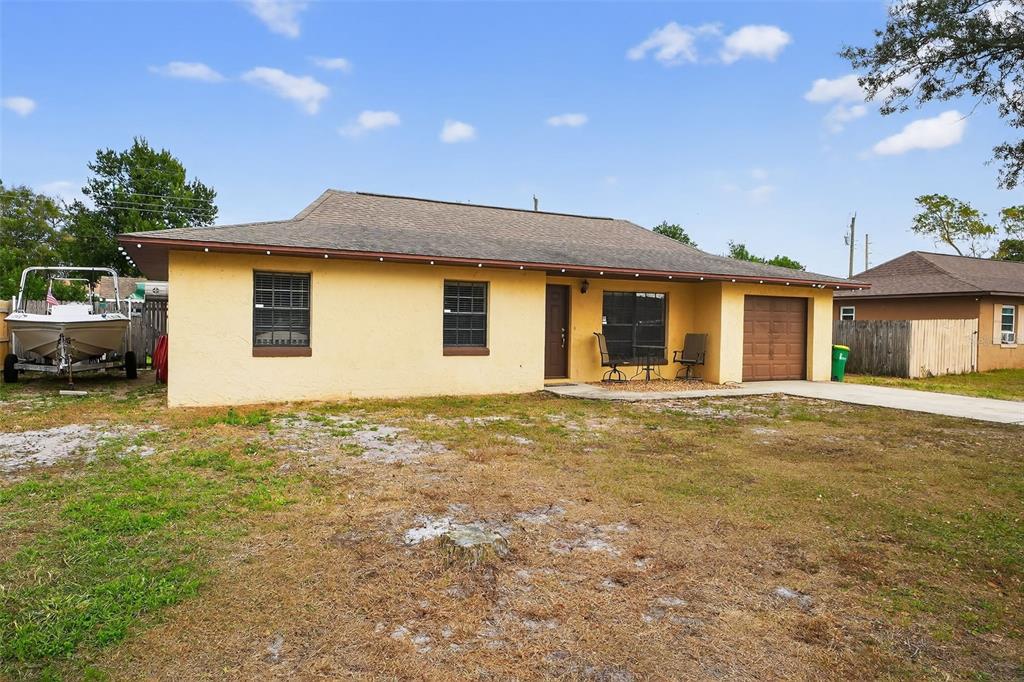 1644 Ruth Street Cocoa, FL 32926 - Photo 35 of 38 a backyard of a house with table and chairs under an umbrella