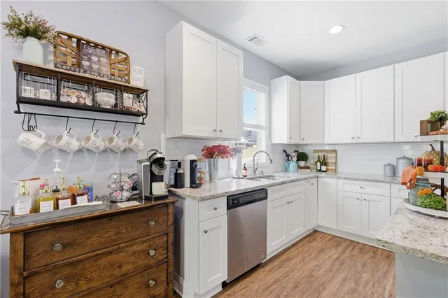 a kitchen with white cabinets and stainless steel appliances