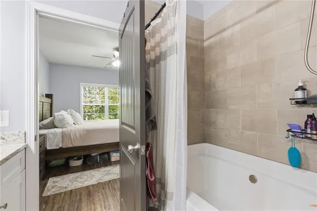 a bedroom with two beds and a flat tv screen