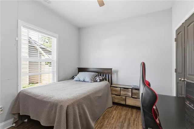 a bathroom with a granite countertop sink a toilet and a mirror