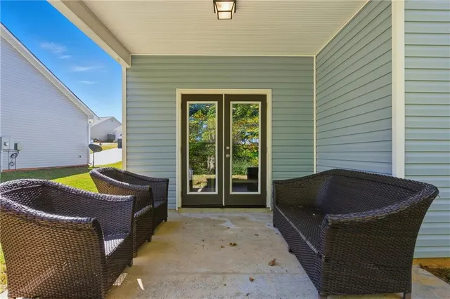 an aerial view of a houses with a lush green hillside