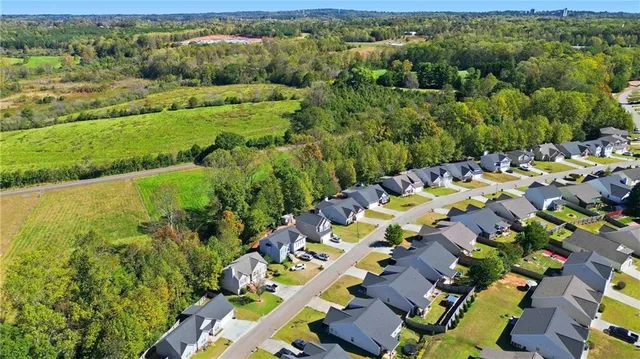 an aerial view of residential houses with outdoor space