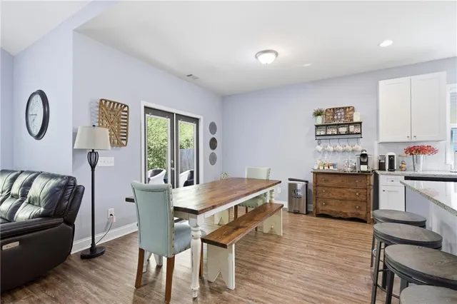 a kitchen with granite countertop a refrigerator cabinets and wooden floor
