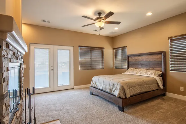 a bedroom with a bed and a chandelier