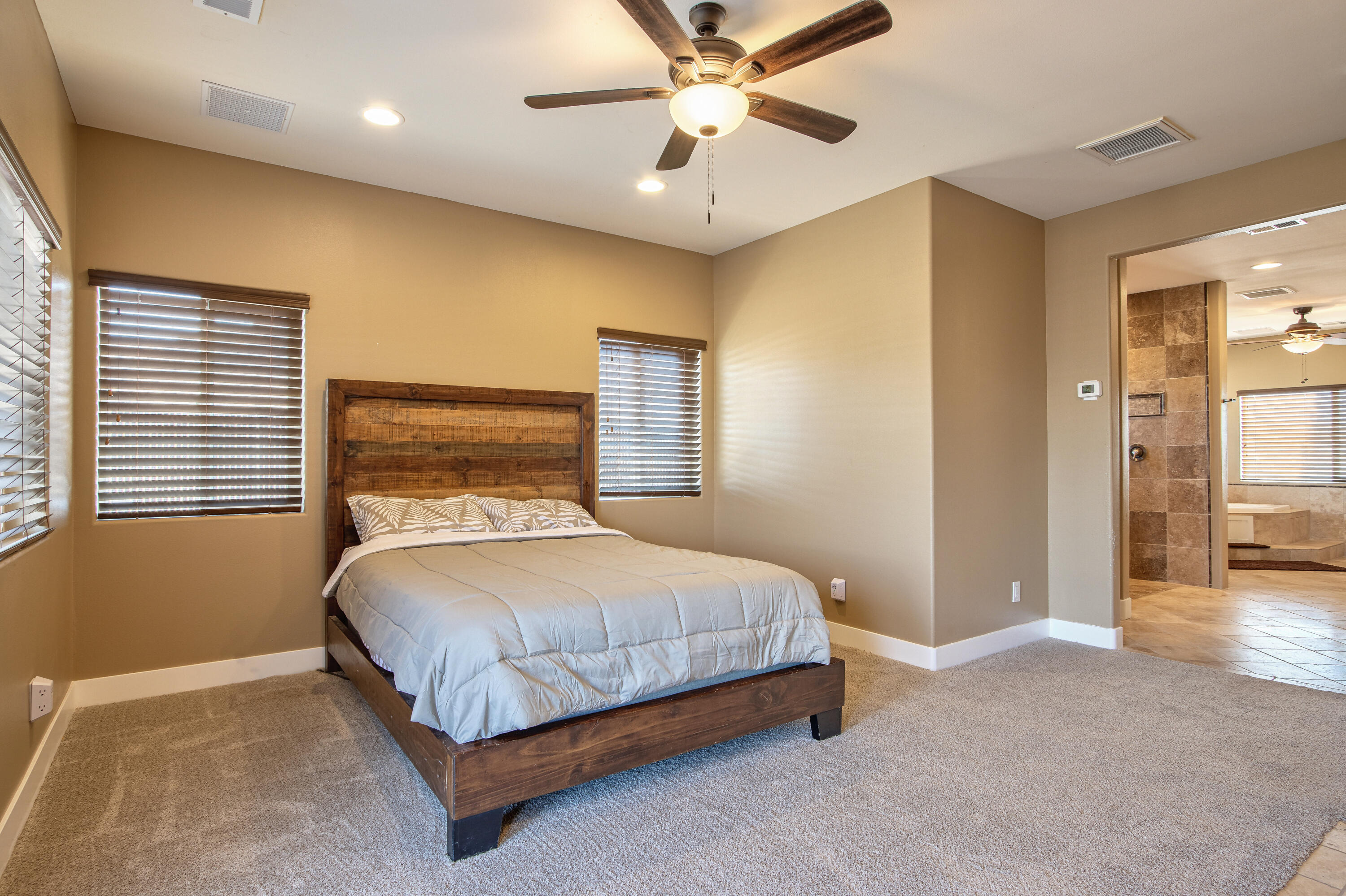 7225 Adobe Road Twentynine Palms, CA 92277 - Photo 17 of 61 a bedroom with a bed and a chandelier