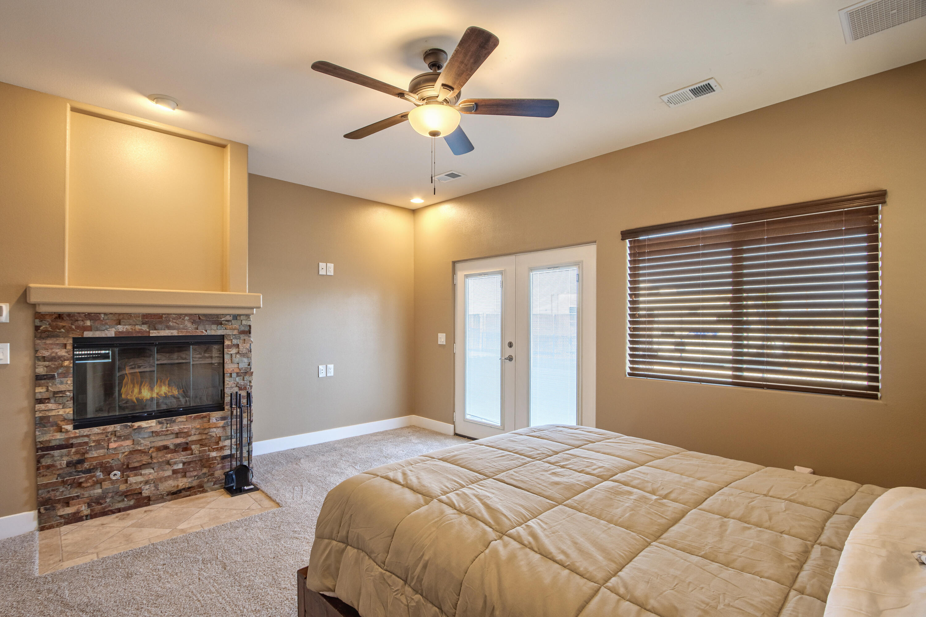7225 Adobe Road Twentynine Palms, CA 92277 - Photo 18 of 61 a bedroom with a bed and a fireplace