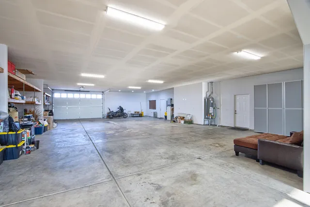 a view of a hallway with wooden floor and a bathroom view
