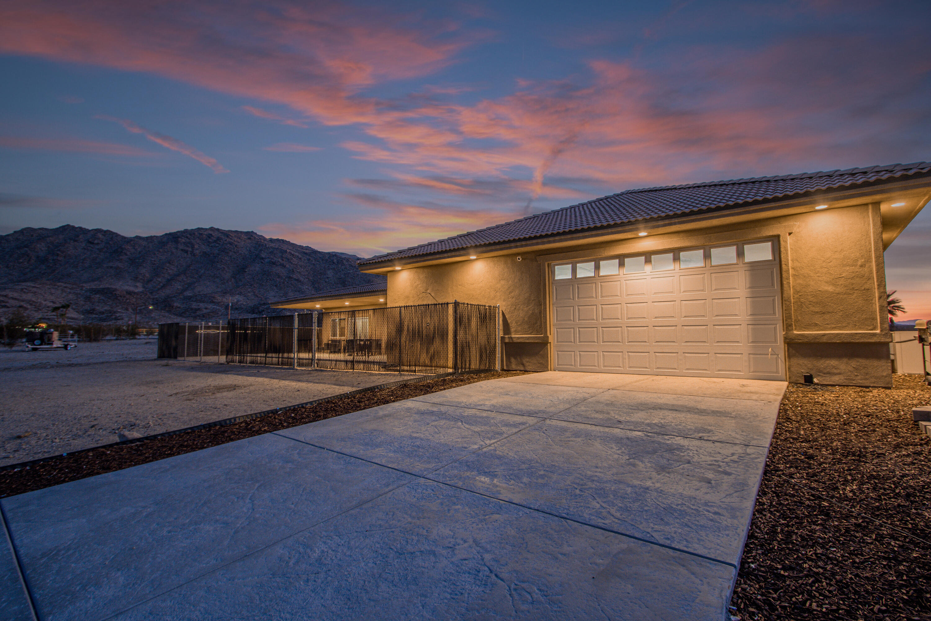 7225 Adobe Road Twentynine Palms, CA 92277 - Photo 49 of 61 a front view of a house with a yard and garage