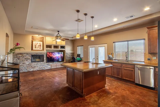 a living room with furniture a flat screen tv and a fireplace