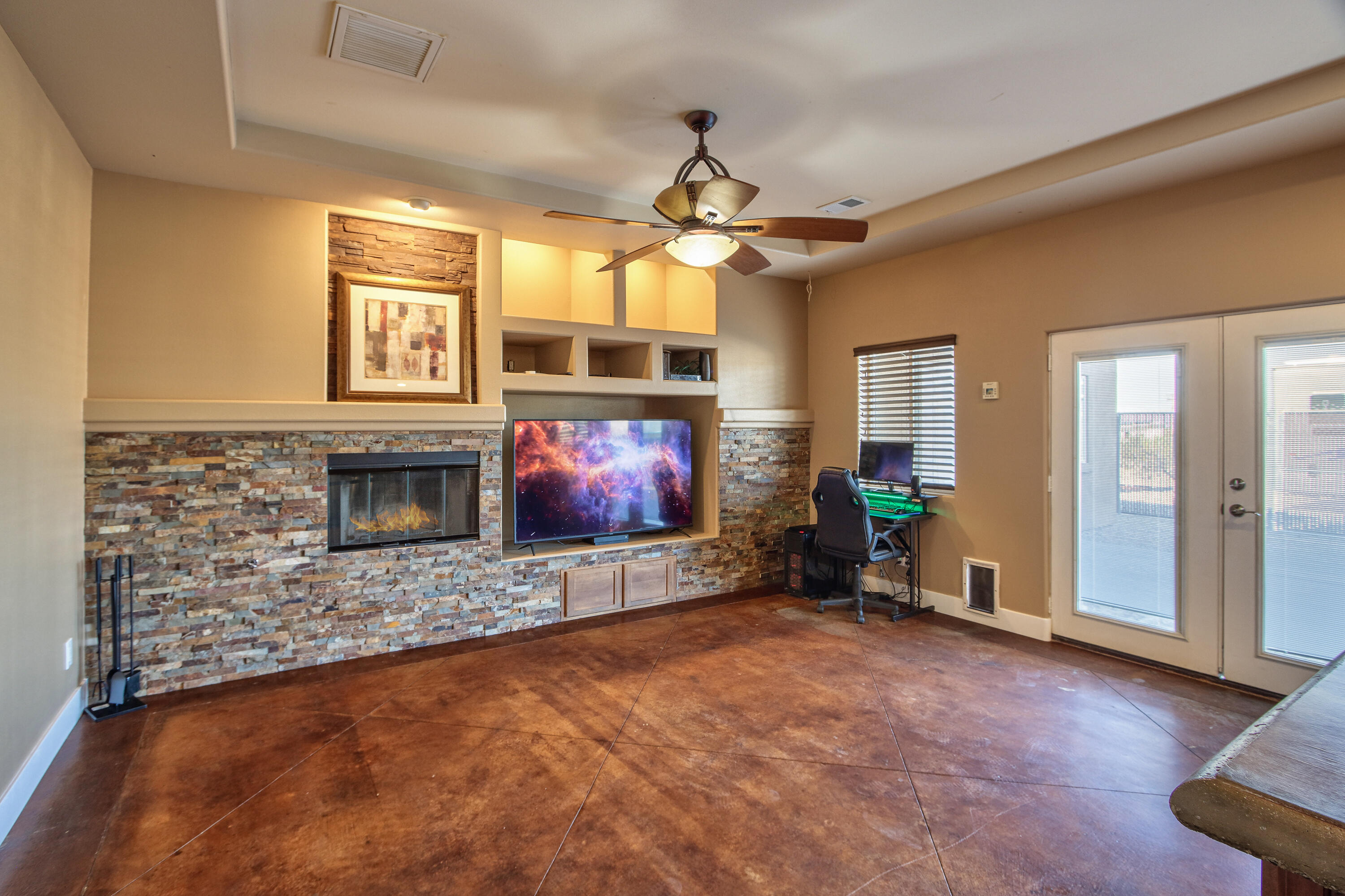 7225 Adobe Road Twentynine Palms, CA 92277 - Photo 9 of 61 a living room with furniture a flat screen tv and a fireplace