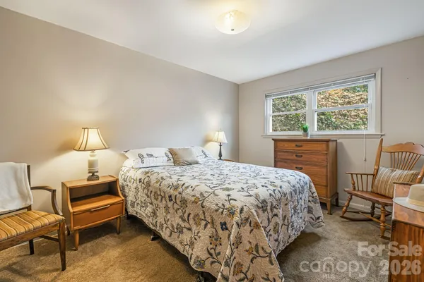 a bed room with a bed and a chair