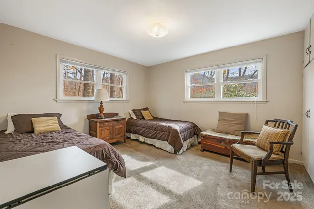 a bedroom with two beds and a couch