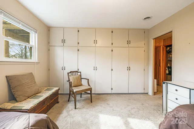 a bedroom with furniture and a window
