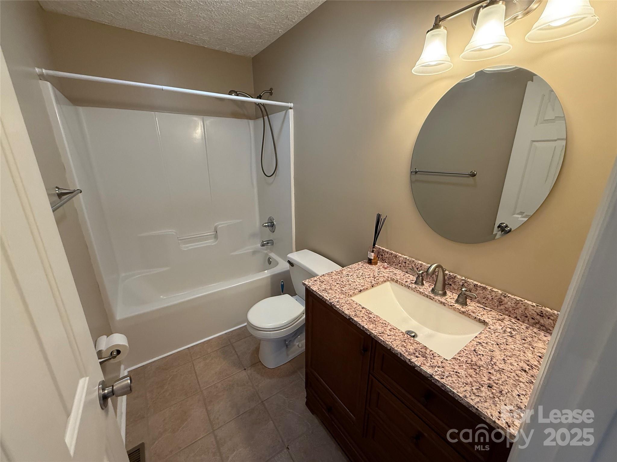 117 Hayworth Lane, Unit 19 Statesville, NC 28625 - Photo 12 of 18 a bathroom with a granite countertop sink toilet and shower