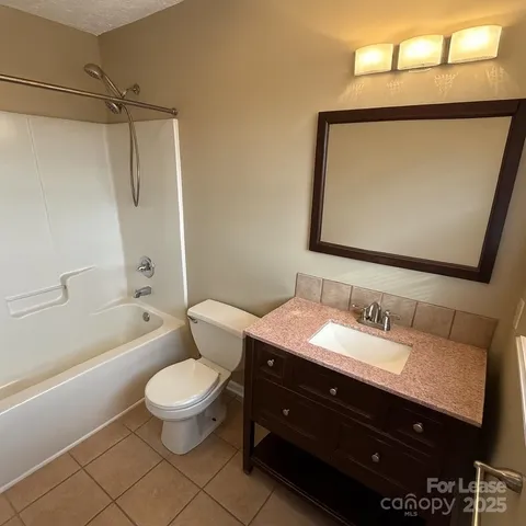 a bathroom with a double vanity sink toilet mirror and shower