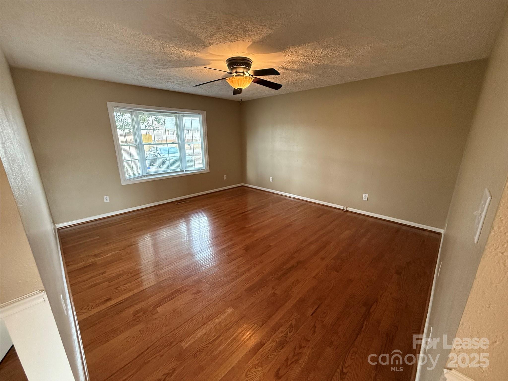 117 Hayworth Lane, Unit 19 Statesville, NC 28625 - Photo 6 of 18 wooden floor in an empty room with a window