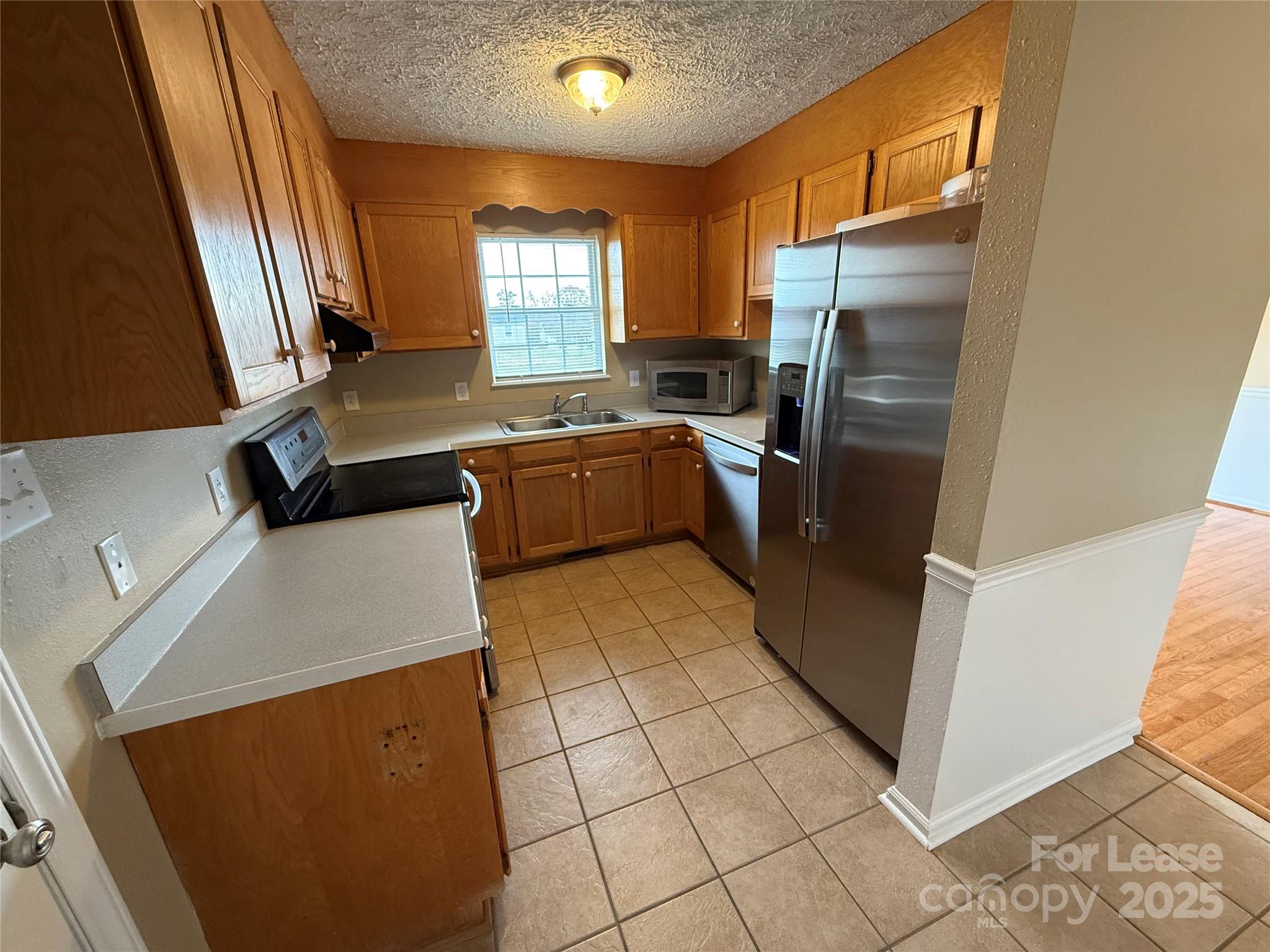 117 Hayworth Lane, Unit 19 Statesville, NC 28625 - Photo 9 of 18 a kitchen with stainless steel appliances a refrigerator sink and microwave