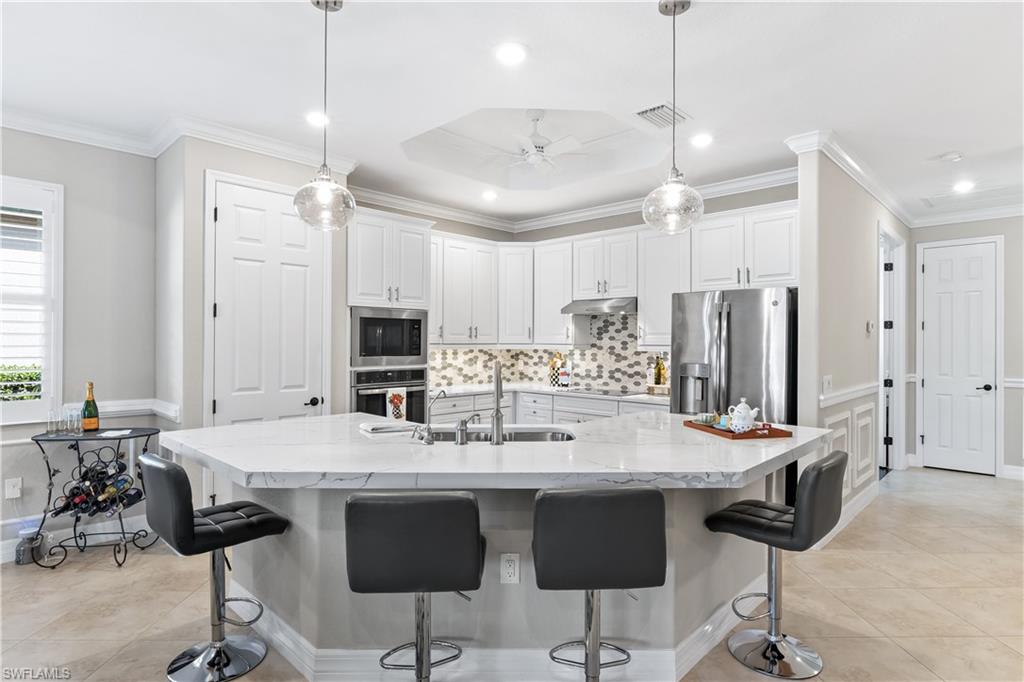 12735 Kinross Lane Naples, FL 34120 - Photo 7 of 37 Renovated kitchen with quartz, custom backslash