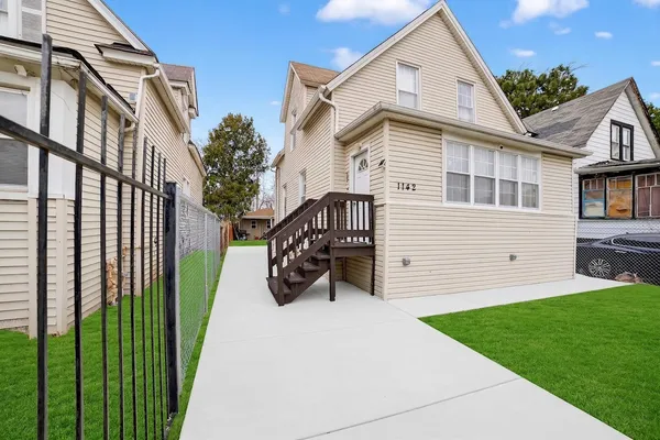 a view of backyard with a garden and deck