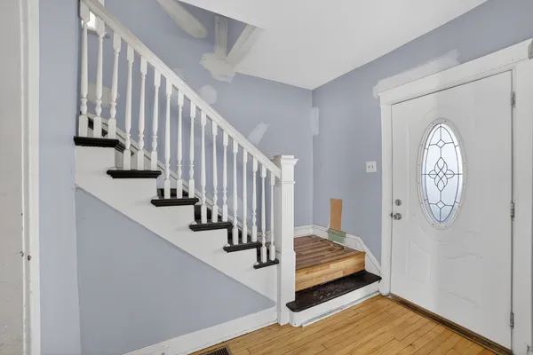 a view of a hallway with wooden floor and entryway