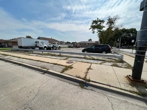 a childrens park with lots of buildings and cars parked