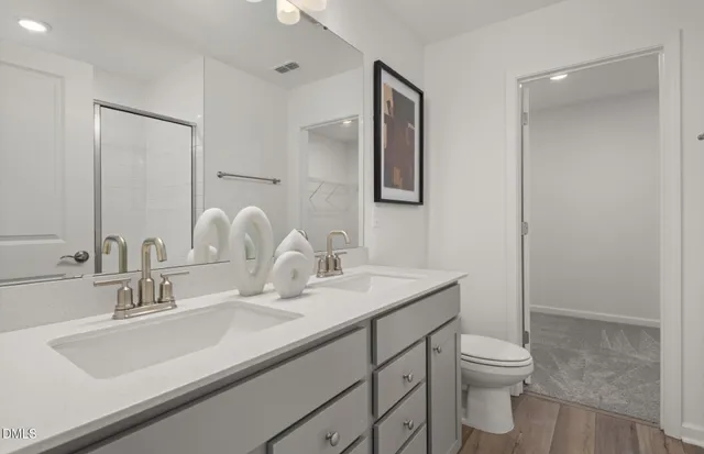 a bathroom with a sink vanity granite tub and shower