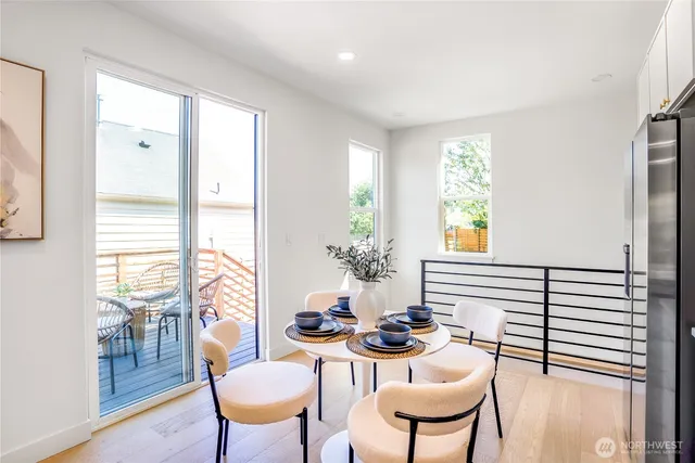 a dining room with furniture and wooden floor