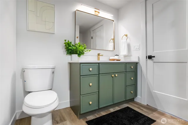 a bathroom with a toilet sink and mirror