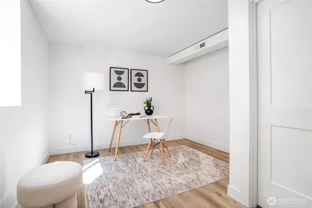 a workspace with furniture and a wooden floor