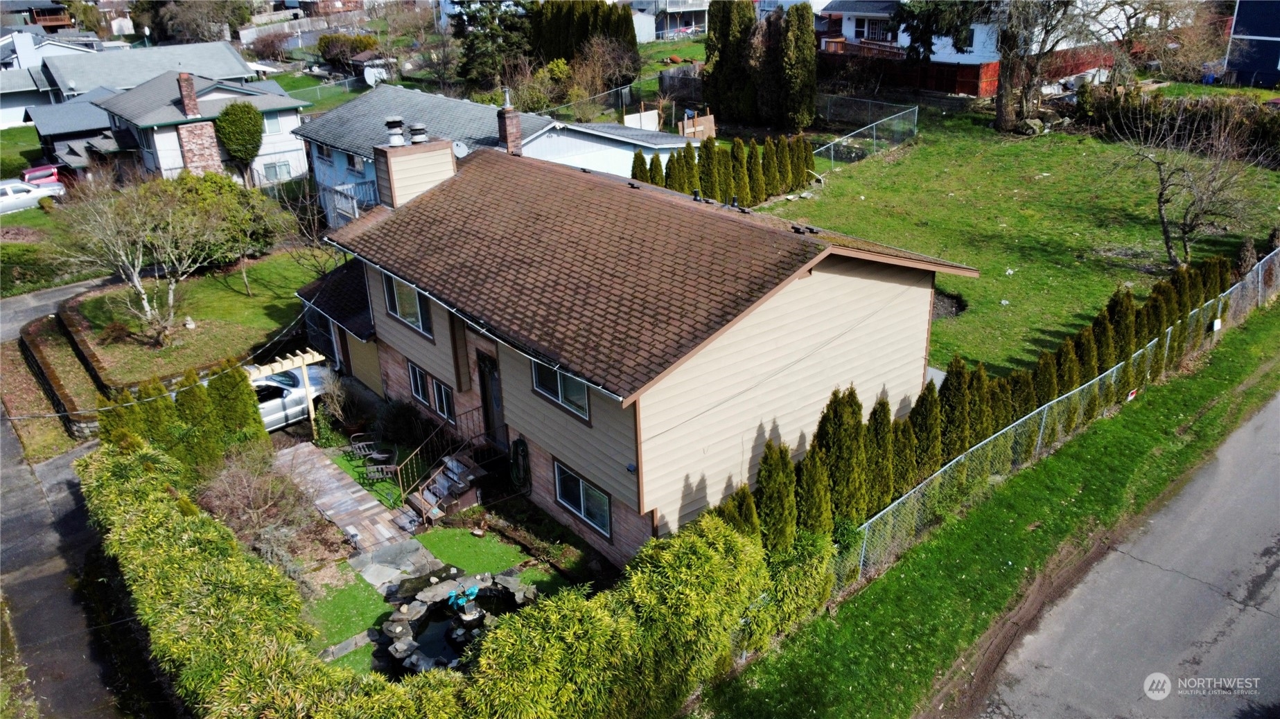 an aerial view of multiple houses with a yard