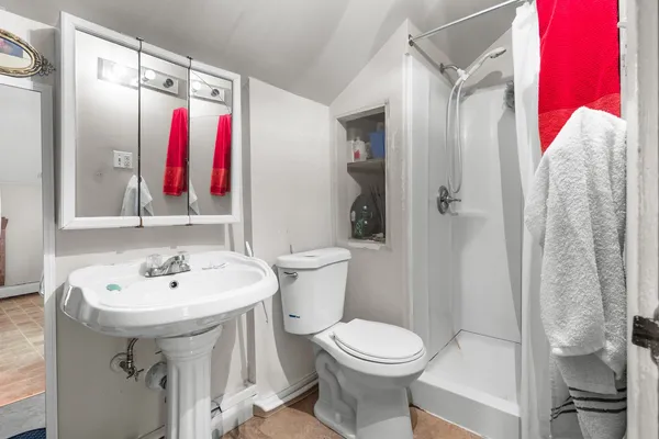 a bathroom with a sink toilet and shower