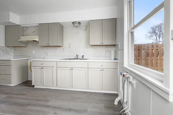 a kitchen with a sink cabinets and window