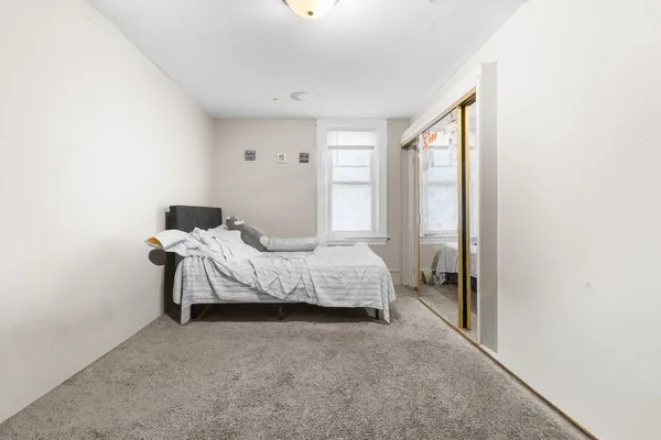 a bedroom with a bed and a window