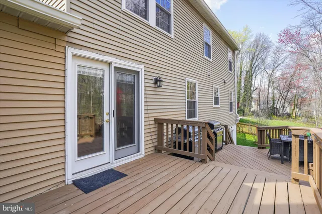 a view of a roof deck with wooden floor and fence