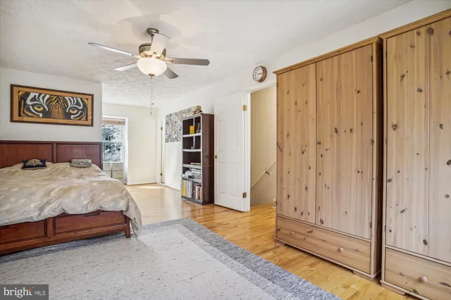 a spacious bedroom with a bed and a chandelier