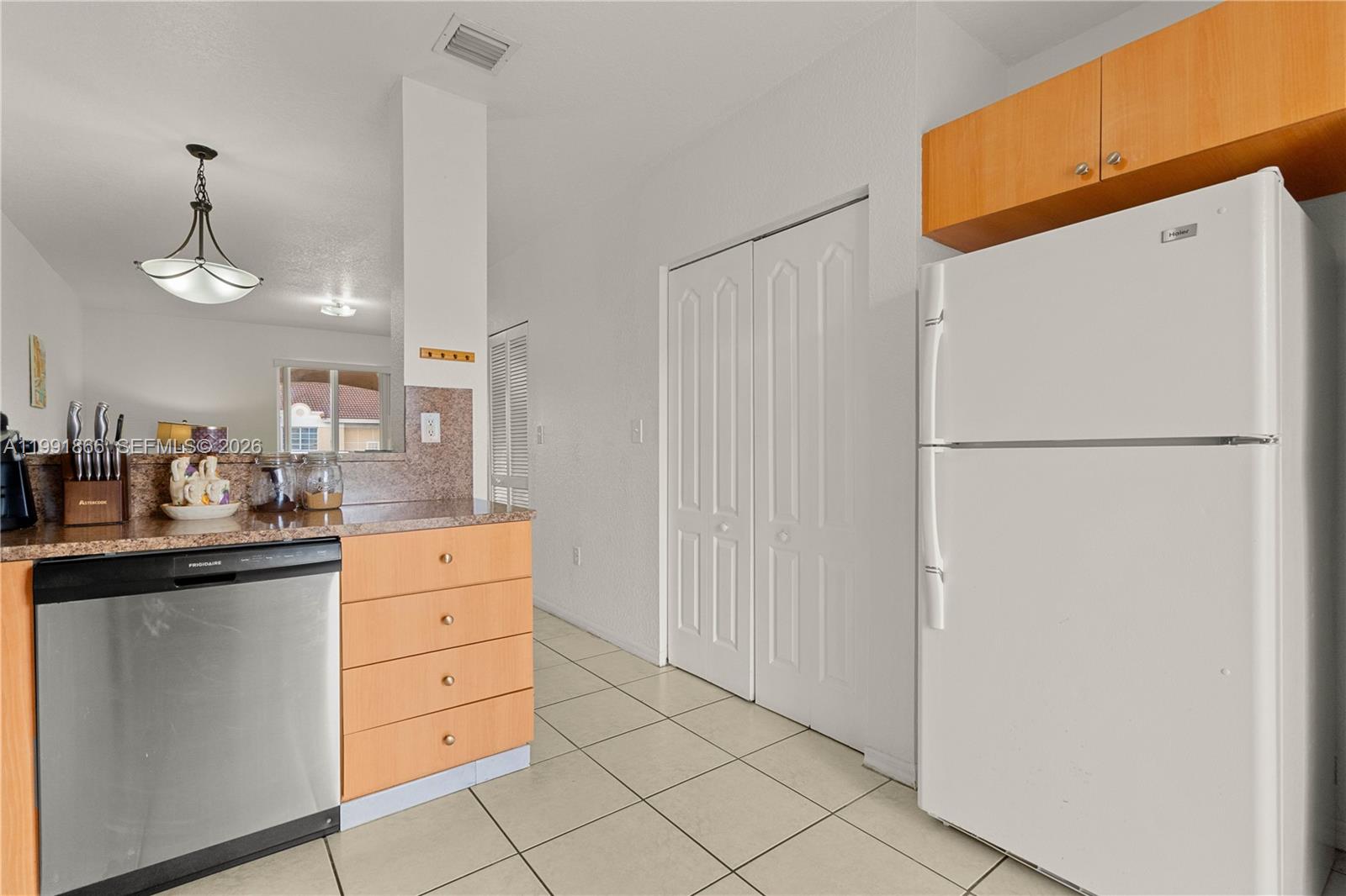 317 East 3rd Street, Unit 201 Hialeah, FL 33010 - Photo 11 of 50 a kitchen with a refrigerator and a stove top oven